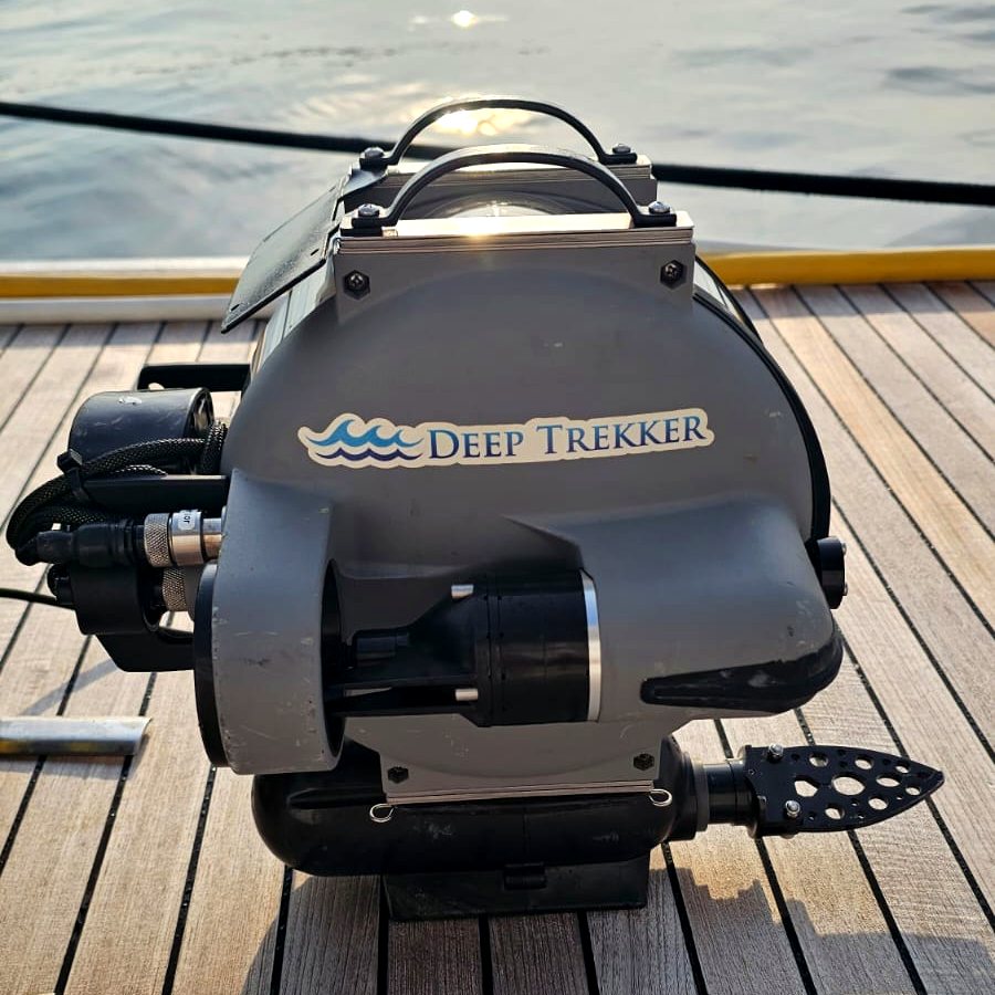 The Deep Trekker DTG2 on a vessel deck, with water and low sun behind it.